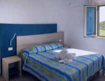 a bedroom with a blue bed in a room